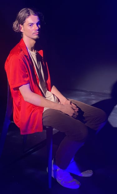 a man sitting in a chair with a guitar