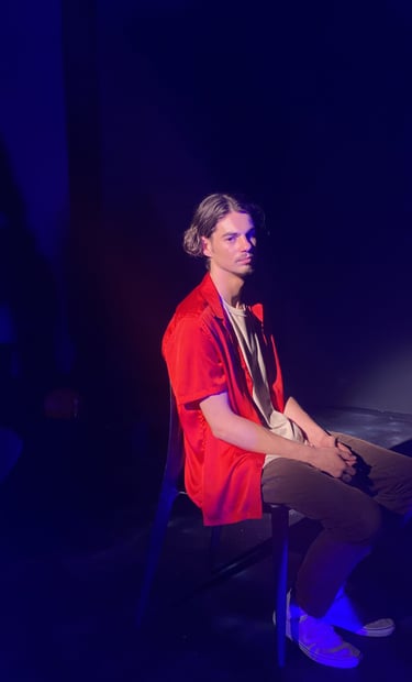 a man sitting in a chair with a guitar