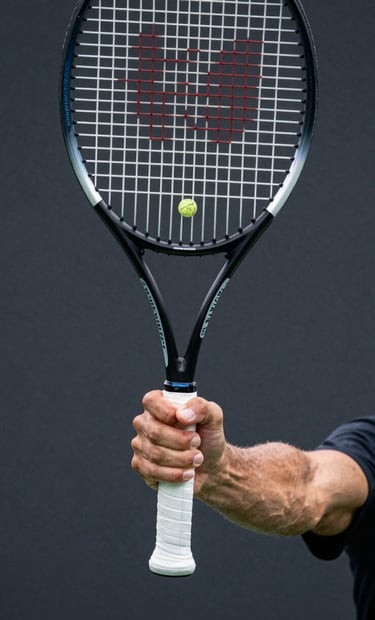 Close-up action shot of a tennis player's hand gripping a racket during a high-speed serve, focus on the tension and texture of the grip, professional sports aesthetic, charcoal black and steel blue color tones, Western / International style.