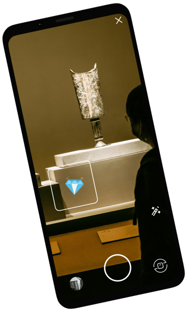 a person standing in front of a art exposition with a diamant sticker 