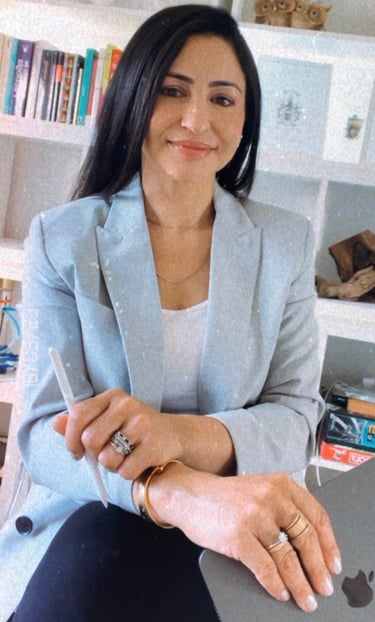 a woman sitting on a chair with a laptop