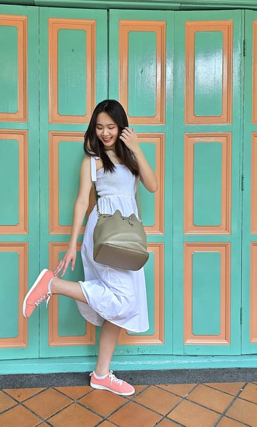 girl looking down at coral canvas shoes | olio my shop