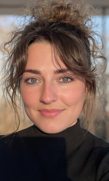 A selfie of a woman with a messy bun