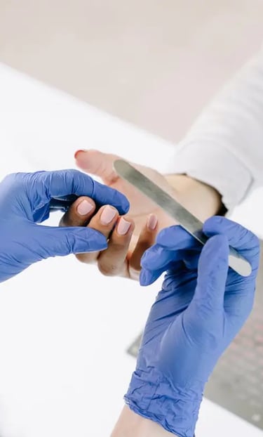 A nail echnician is fixing a customer nails.