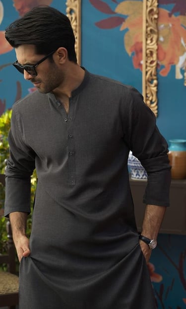 a man in a gray shirt and sunglasses