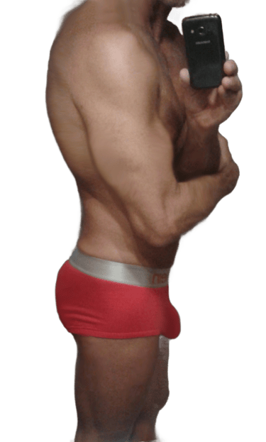 Sexy muscular man in red underwear snapping a selfie showing profile.