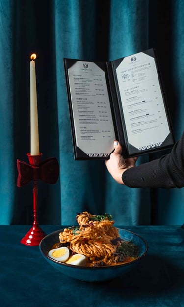 Professional food photography for a Toronto restaurant featuring an aesthetic menu and noodle dish.