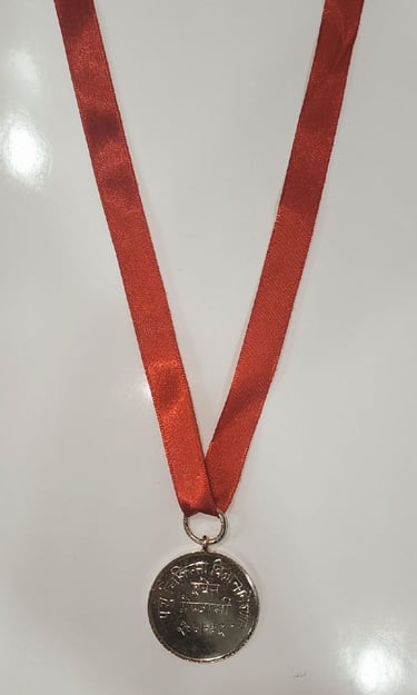 Gold medal with a red ribbon symbolizing achievement and excellence.