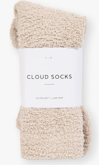 pair of new cream fluffy socks still in packaging