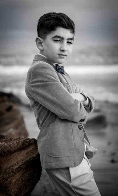 a young boy in a suit and tie