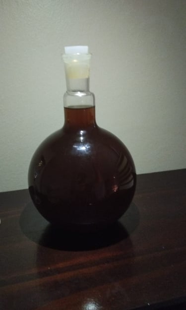 a bottle of liquid in a glass bottle