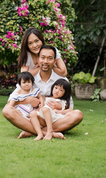Natural family portrait in the garden of a private villa in Seminyak Bali with calm tropical surroundings and genuine