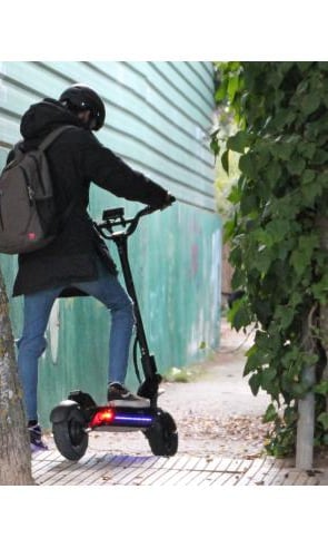a person riding a scooter on a sidewalk