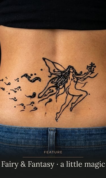 A detailed black ink fairy tattoo with magical sparkles on a woman's lower back.