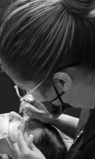 une femme mettant des cils à l'académie Icils avec l'enseignante Irene Molina 