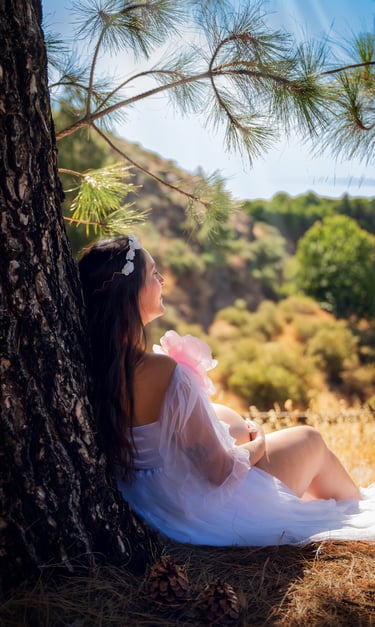 a woman sitting on a tree trunk trunk trunk trunk trunk trunk trunk trunk trunk trunk