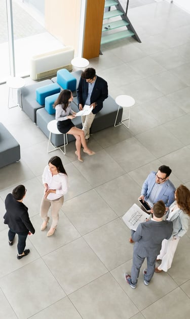 a group of business people standing in a modern open office space