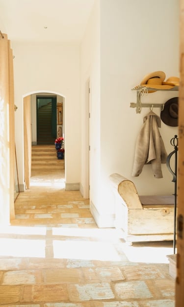 Charming hallway with a coat hanger and bench at Finca Santa Katerina