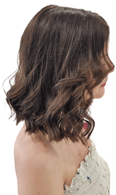 Woman with soft, layered haircut and blow-dry finish