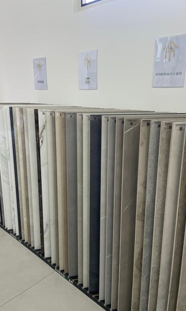 A showroom display featuring a wide selection of porcelain and ceramic floor tiles in various colors and patterns.