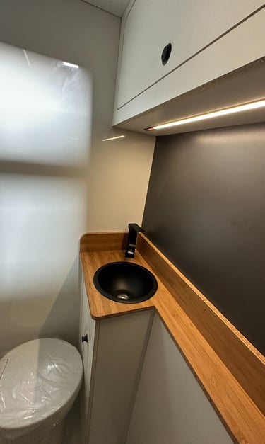 baño interior de una célula camper con acabados de alta gama