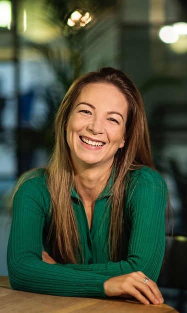 a woman in a green shirt smiling