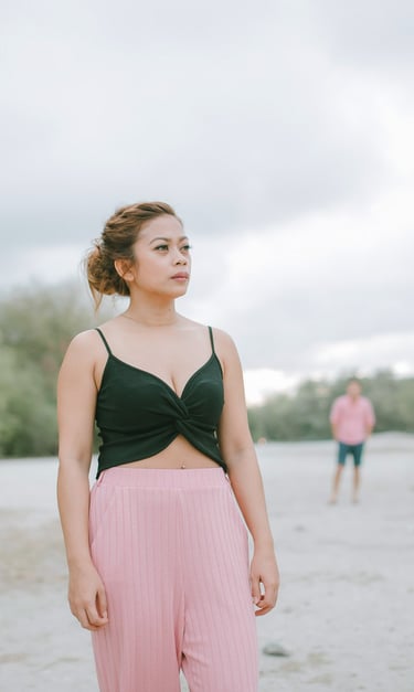 Woman standing on open beach during intimate couple photography session in Serangan Benoa Bali.