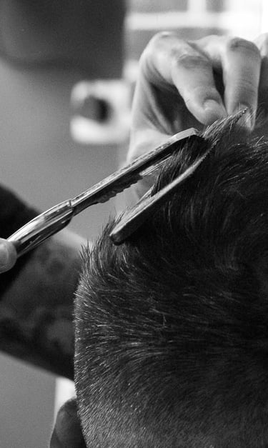 a man is cutting his hair with scissors and scissors