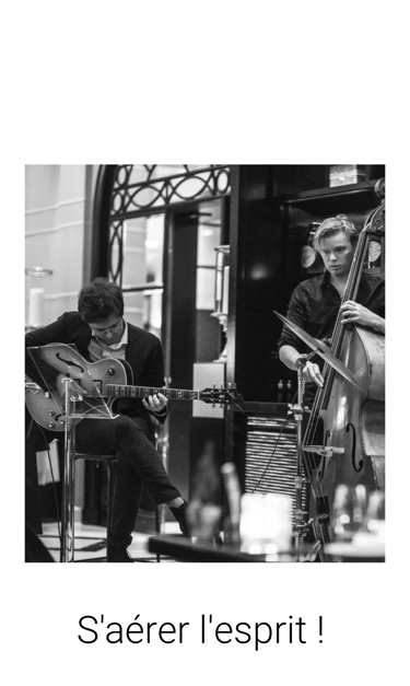 a man playing guitar in a cafe