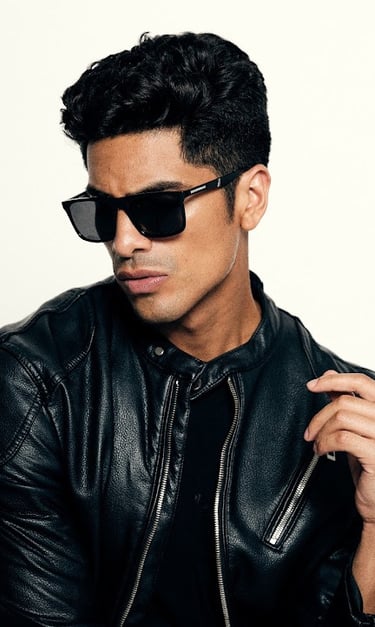 Dany Peña international male model in black leather jacket and sunglasses editorial portrait