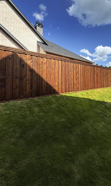 new fence freshly installed and stained