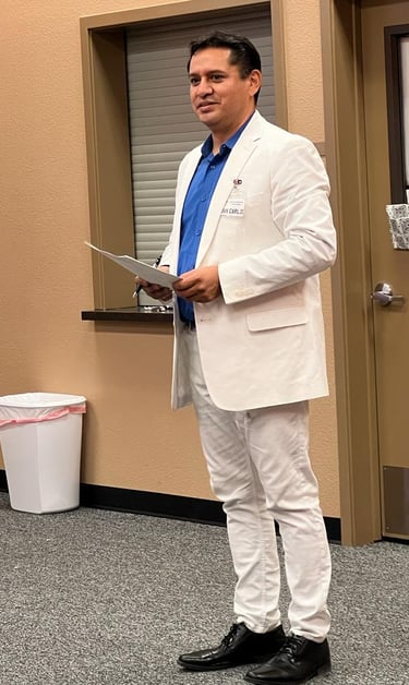 a man in a white suit and blue shirt