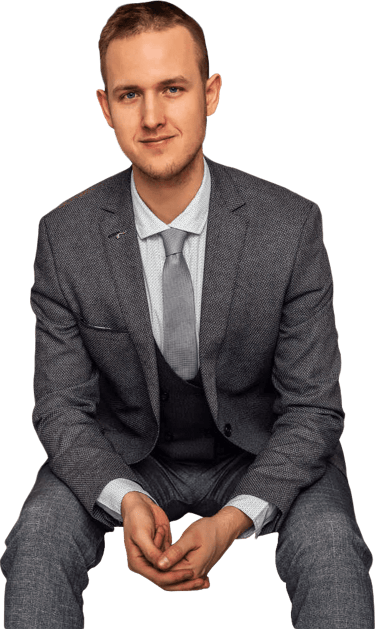 a man in a suit and tie sitting on a chair