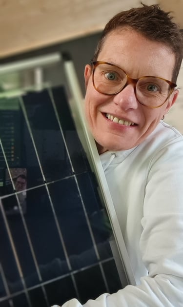 a man in a white shirt and glasses is holding a laptop