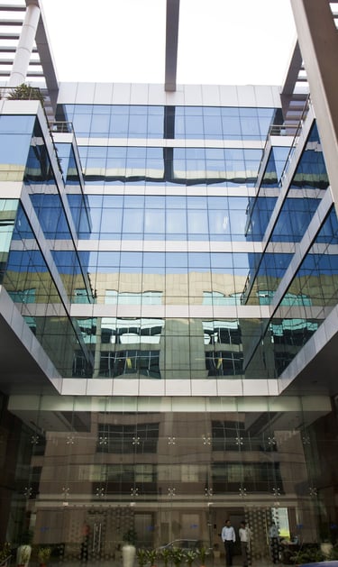 a building with a lot of windows and a car parked in front of it