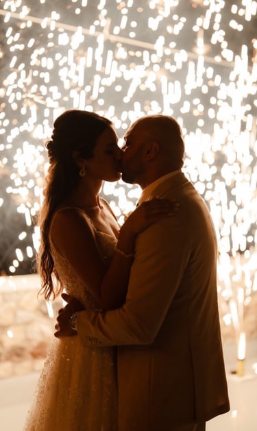 Magical stage fountain fireworks lighting up a Santorini wedding under the stars.