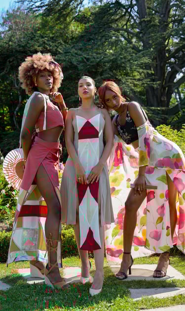 three women models standing in front of a tree