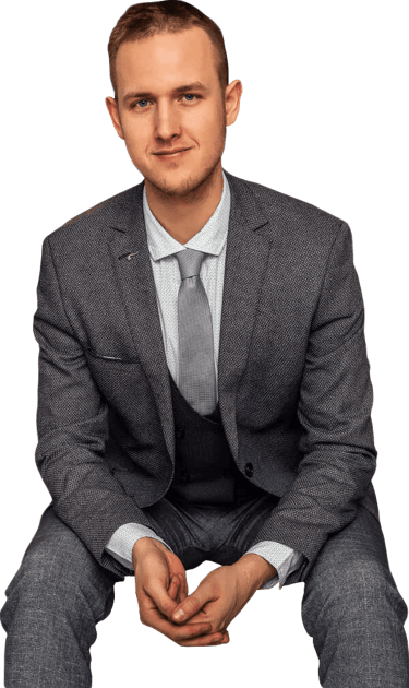 a man in a suit and tie sitting on a chair