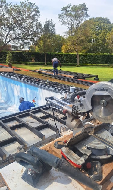 A circular saw , busy with decking around swimming pool