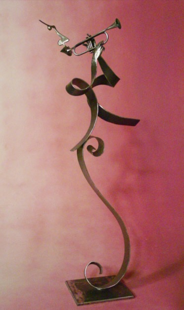a metal sculpture of a man playing a trumpet