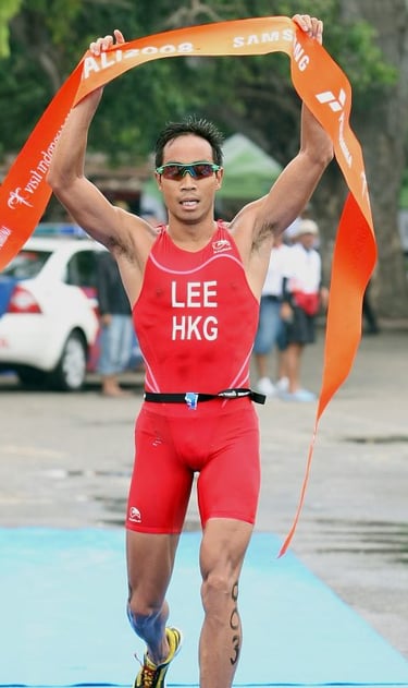 Photo of Daniel Lee, Hong Kong triathlete, crossing the finish line at the Bali 2008 triathlon