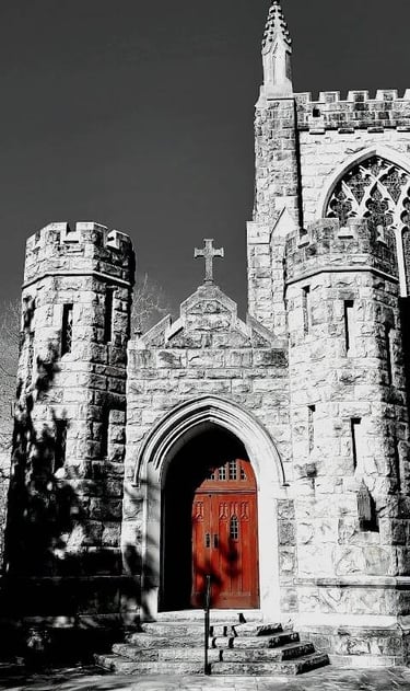 Sewanee - A black & white photo of a church/castle with a large wooden door in reddish brown color