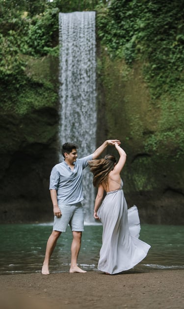 Playful romantic moment during prewedding at Tibumana Waterfall Bangli Bali