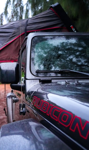 a black and red jeep with a black tent