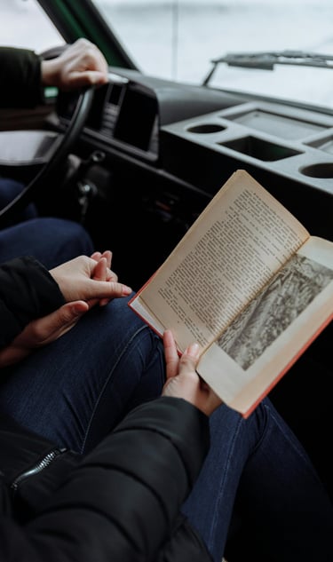 two people holding hans and readning a book