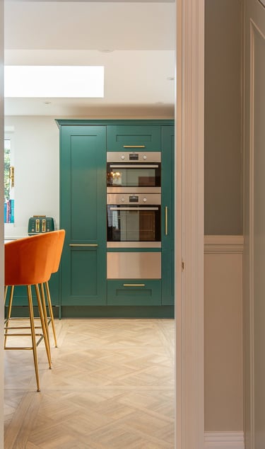 green howden kitchen, orange bar stools, paraquet flooring