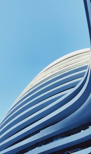 a building with a large curved building in the background