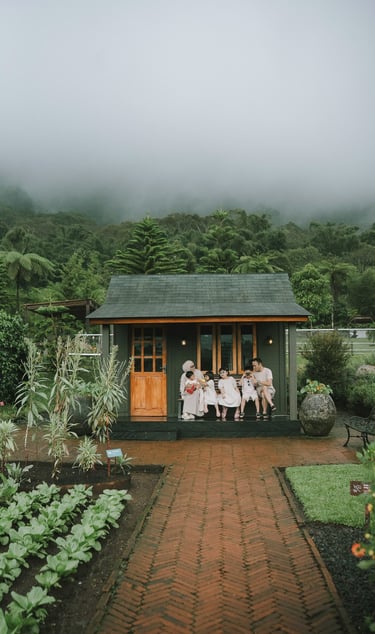 Family walking in rain during a family photography session at Rumah Gemuk Bedugul Bali.