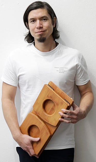 Teacher and founder Jeff holding a self-made meditation bench