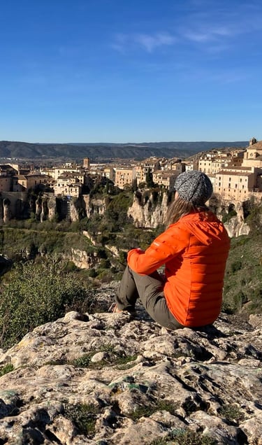 inspirella sitting on the rocks, overlooking Cuenca in Spain